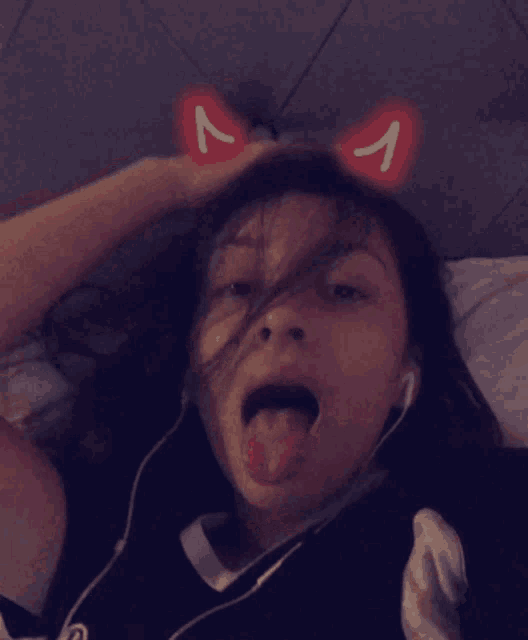 a girl wearing a cat ear headband with a letter a on it