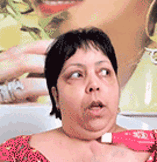 a woman is holding a red marker in front of a poster of a woman 's face .