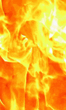 a close up of a fire with a lot of flames and smoke