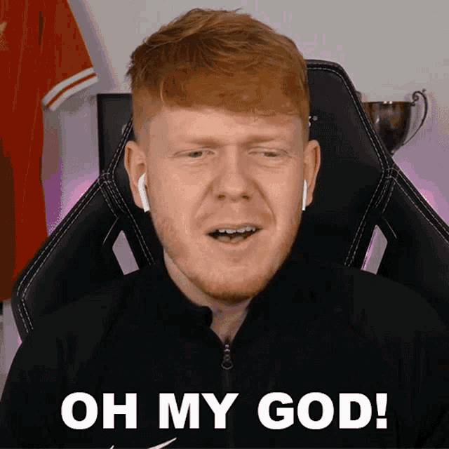 a man sitting in a chair with the words oh my god on the bottom
