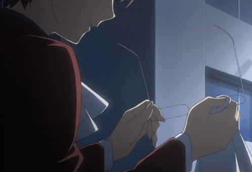 a person is holding a pair of glasses in their hand