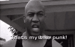 a man is making a funny face and saying `` that 's my lunch punk '' .