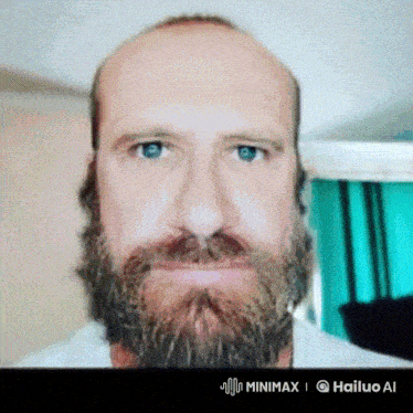 a bald man with a beard and blue eyes looks at the camera with a hailuo ai logo below him