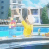 a person in a yellow shirt is standing next to a pool .