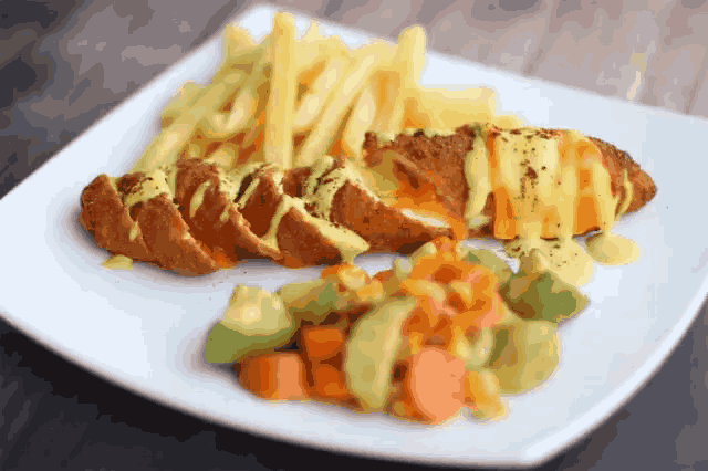 a plate of food with french fries and vegetables on it