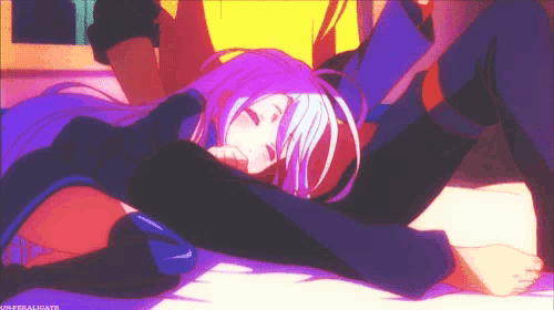 a girl with purple hair is laying on top of a man 's lap .