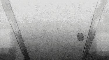 a black and white photo of a door with a circle on it