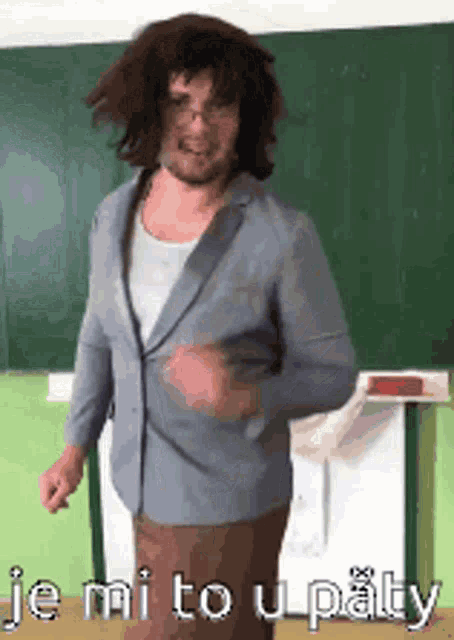 a man in a suit is dancing in front of a green board that says je mi to u patty