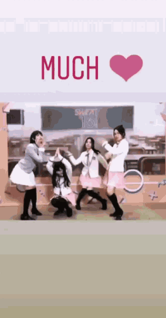 a group of girls are posing in front of a chalkboard that says much on it