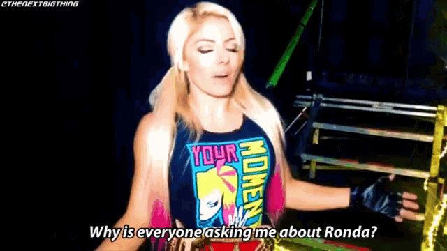 a woman wearing a shirt that says your moment is asking why is everyone asking me about ronda .