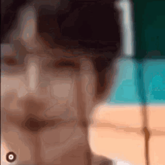 a blurry picture of a person 's face with a blurred background