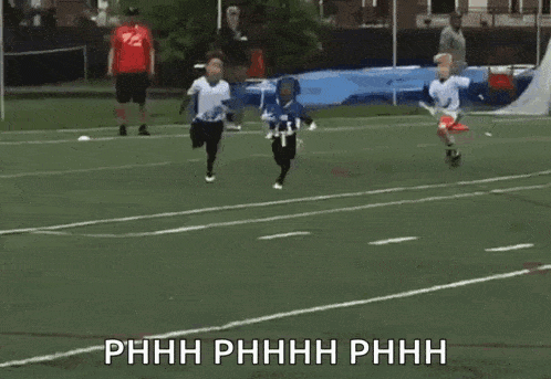 a group of young boys are playing a game of frisbee on a field .