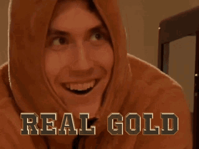 a man wearing a hoodie with the words real gold on the bottom