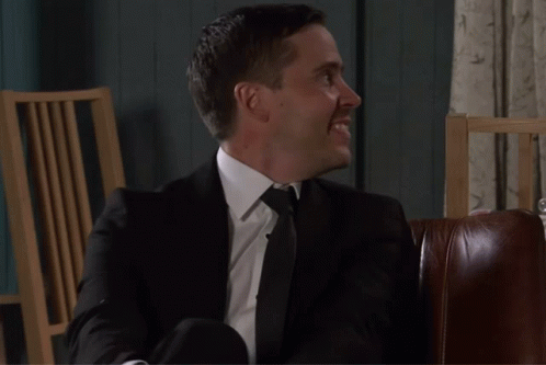 Todd Smiling While Sitting Down And Looking From Right To Centre Coronation Street GIF - Todd Smiling While Sitting Down And Looking From Right To Centre Coronation Street Corrie GIFs
