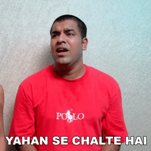 a man wearing a red polo shirt says yahan se chalte hai