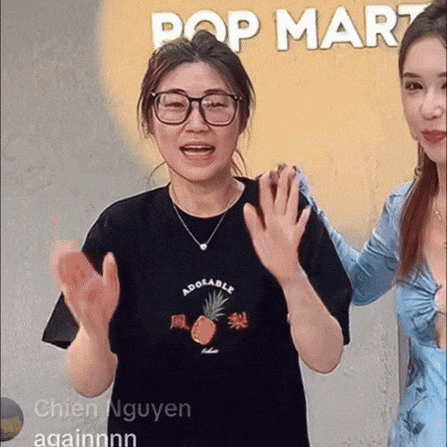 a woman wearing a black shirt that says adorable applauds