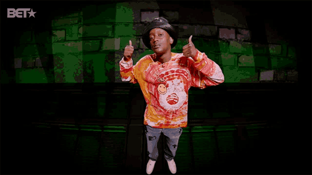 a man giving a thumbs up in front of a bet star logo