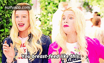 two blonde women are standing next to each other and one of them is saying `` you breast feed like this . ''