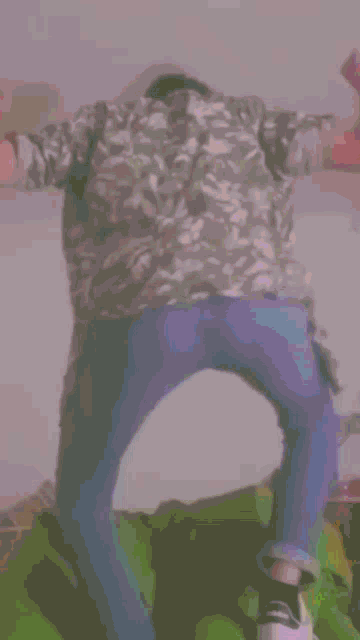 a person in a pink shirt and blue jeans is standing on a bed with their arms outstretched