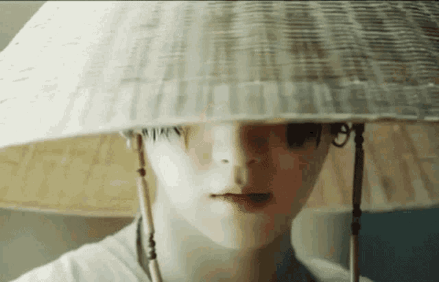 a close up of a person wearing a white hat .
