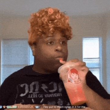 a man drinking from a cup with wendy 's logo