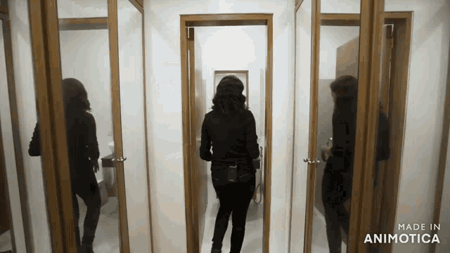 a woman standing in a room with the words made in animotica on the bottom right