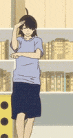 a girl in a blue shirt and black skirt is standing in front of a bookshelf with books on it .