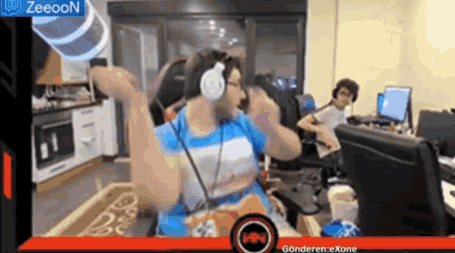 a man wearing headphones is sitting in front of a screen that says zeeoon