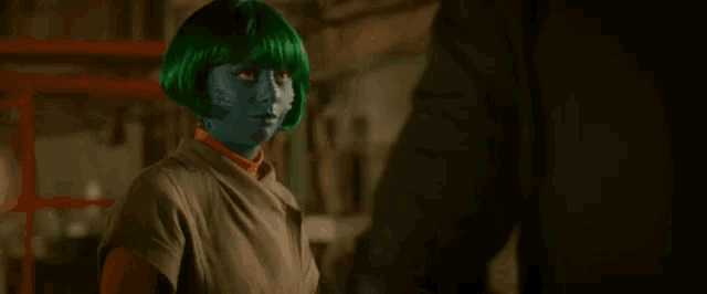 a woman with green hair and blue paint on her face says " you should talk "