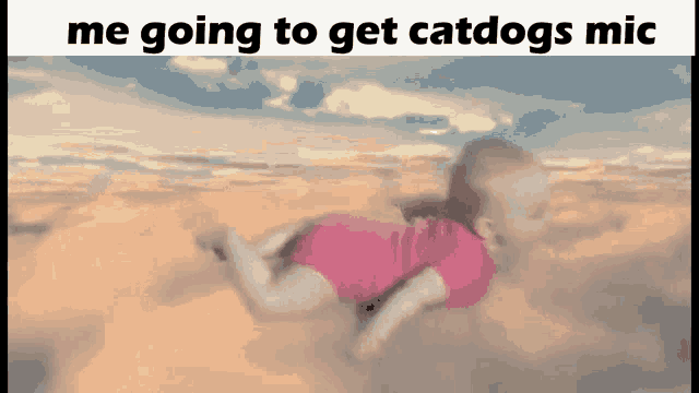 a baby is flying through the air with the words `` me going to get catdogs mic '' below it .