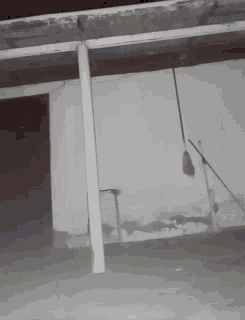 a broom is hanging from the ceiling of an empty building