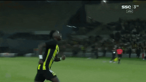 a soccer player is kneeling down on the field with ssc written on the bottom of the screen