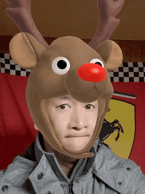 a person wearing a reindeer hat with antlers and a red nose
