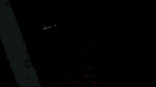 a skeleton with a horn on its head is standing in a dark room