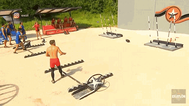 a group of people are playing a game on a sandy field .