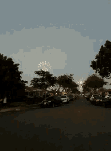 a row of cars are parked on the side of the road in a residential area