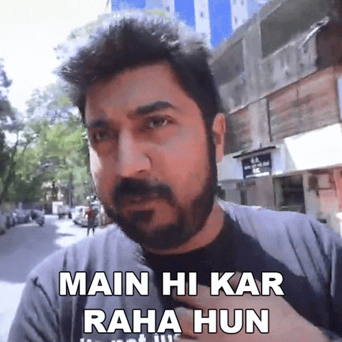 a man with a beard says " main hi kar raha hun " in front of a building