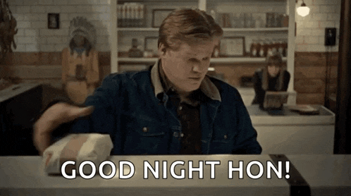 a man in a denim jacket is sitting at a counter with a bag of food and says good night hon .
