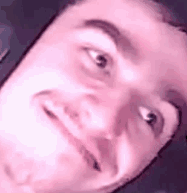 a close up of a man 's face making a funny face with his eyes closed .