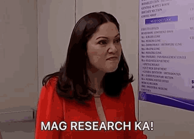 a woman is standing in front of a sign that says mag research ka !