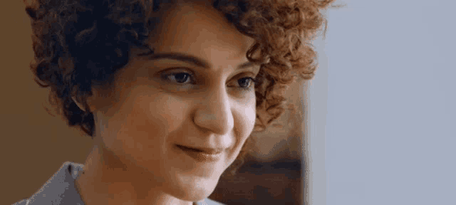 a close up of a woman with curly hair