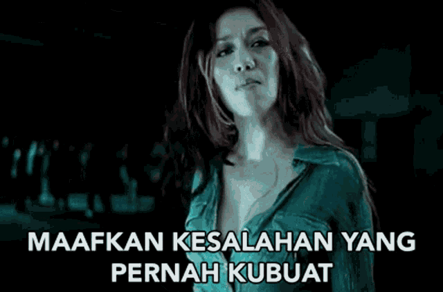 a woman with red hair is screaming in a dark room with a caption that says maafkan kesalahan yang pernah kubuat .