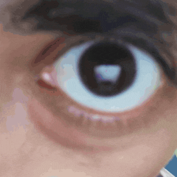 a close up of a person 's eye with a triangle in it
