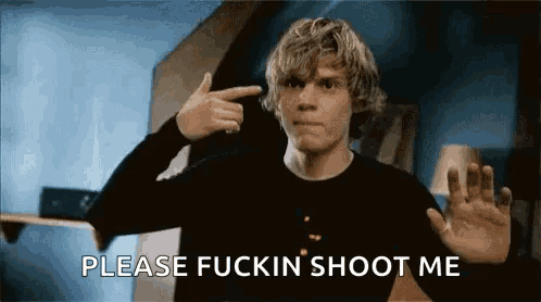 a man is pointing his finger at his head and asking for someone to shoot him .