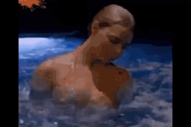 a naked woman is swimming in a pool at night .