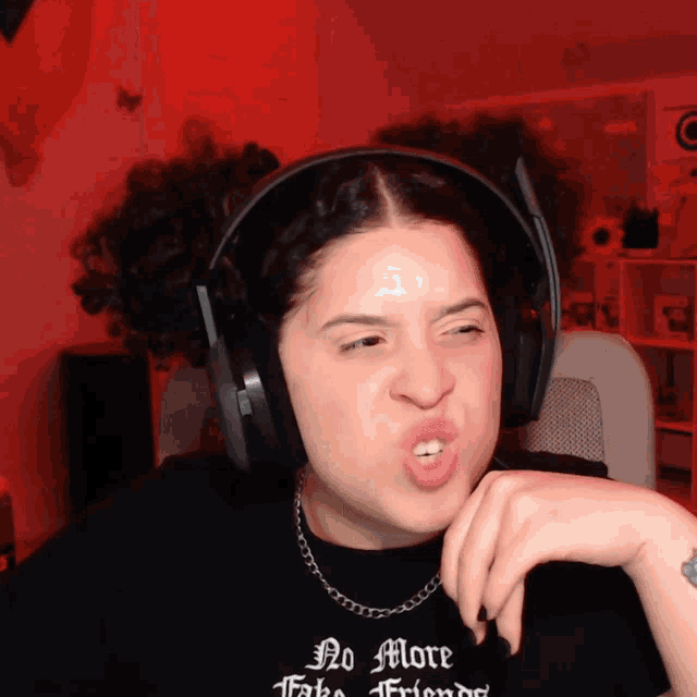 a woman wearing headphones and a t-shirt that says no more friends