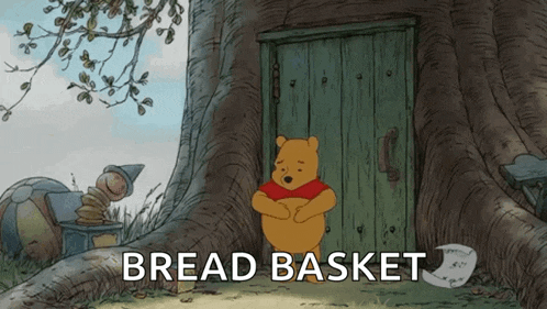 a cartoon of winnie the pooh standing in front of a tree with the words bread basket below him