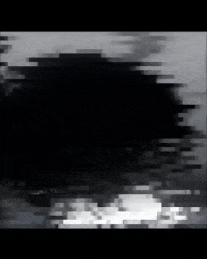 a black and white photo of a person 's face reflected in the water