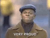 a man wearing a hat and a brown coat is very proud .