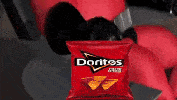 a bag of doritos nacho cheese chips is being held by a robot